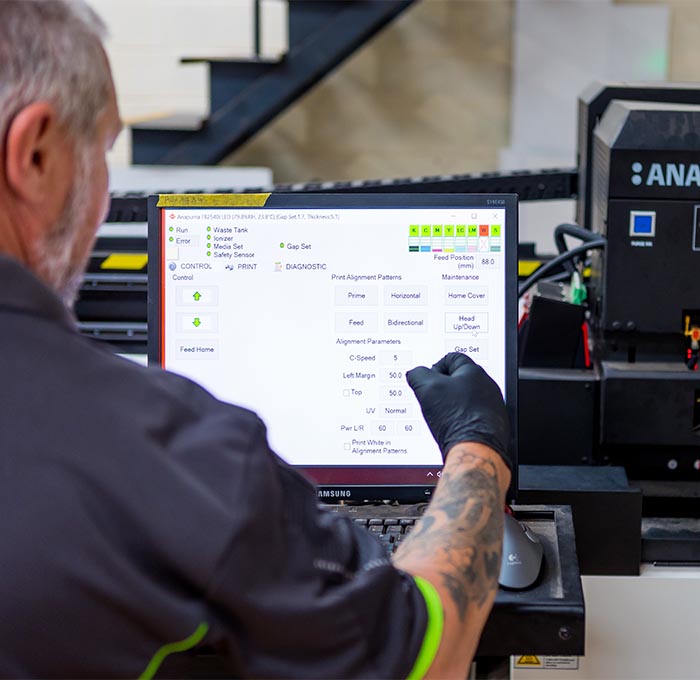 Printer adjusting printing press settings at Greenridge Group